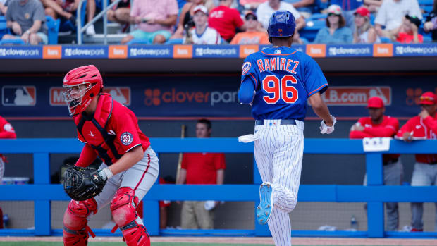 Feb 26, 2023; Port St. Lucie, Florida, USA; New York Mets outfielder Alex Ramirez crosses the plate to score as Washington Nationals catcher Brady Lindsly waits on the ball during the seventh inning at Clover Park.